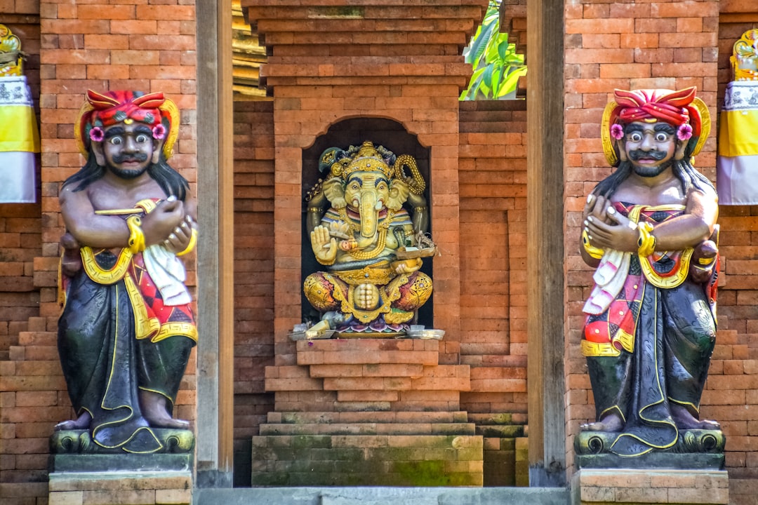hindu deity statue in front of brown wooden door