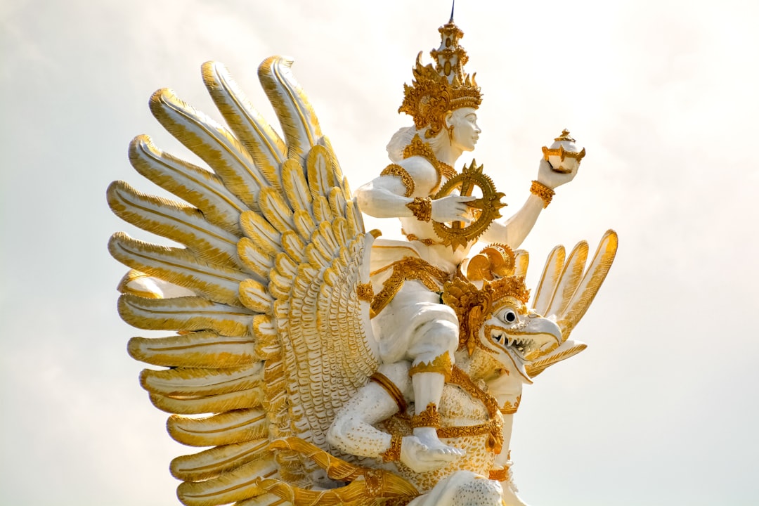 gold dragon figurine on white surface