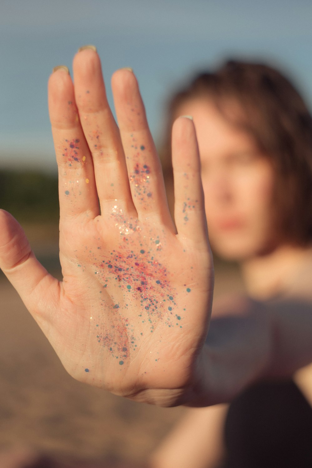 woman with pink powder on her hand