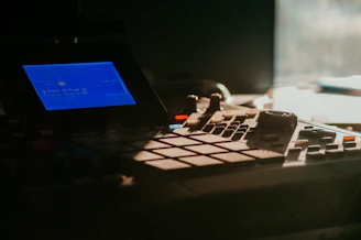 Close-up of a music producer using l-prompter plugin on a computer screen in a dark studio.