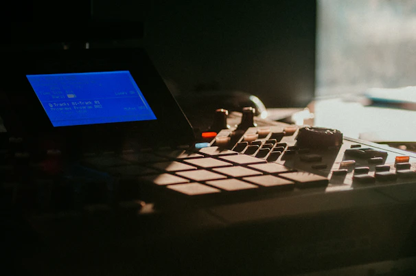 Close-up of a music producer using l-prompter plugin on a computer screen in a dark studio.