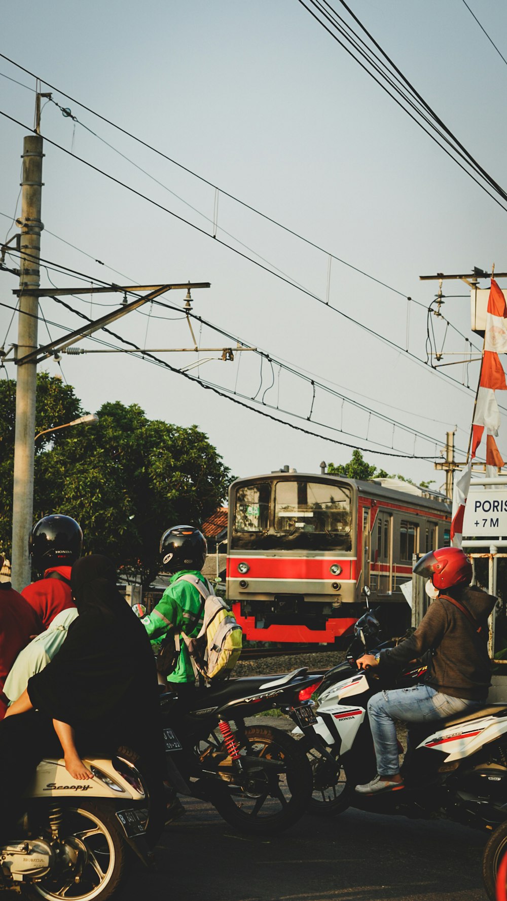 people riding red and green tram during daytime