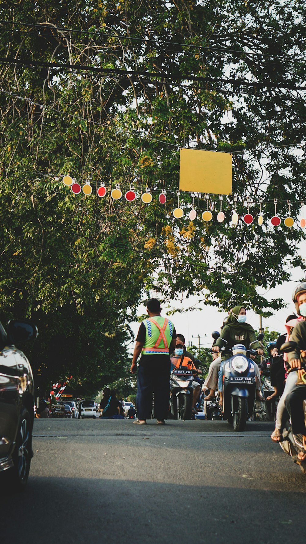 man in white t-shirt and blue denim jeans standing on motorcycle during daytime