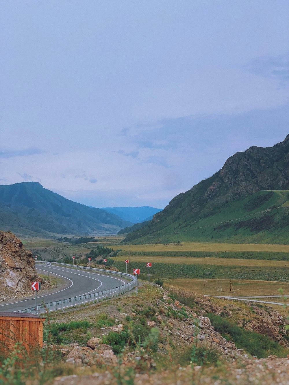 cars on road near mountain during daytime