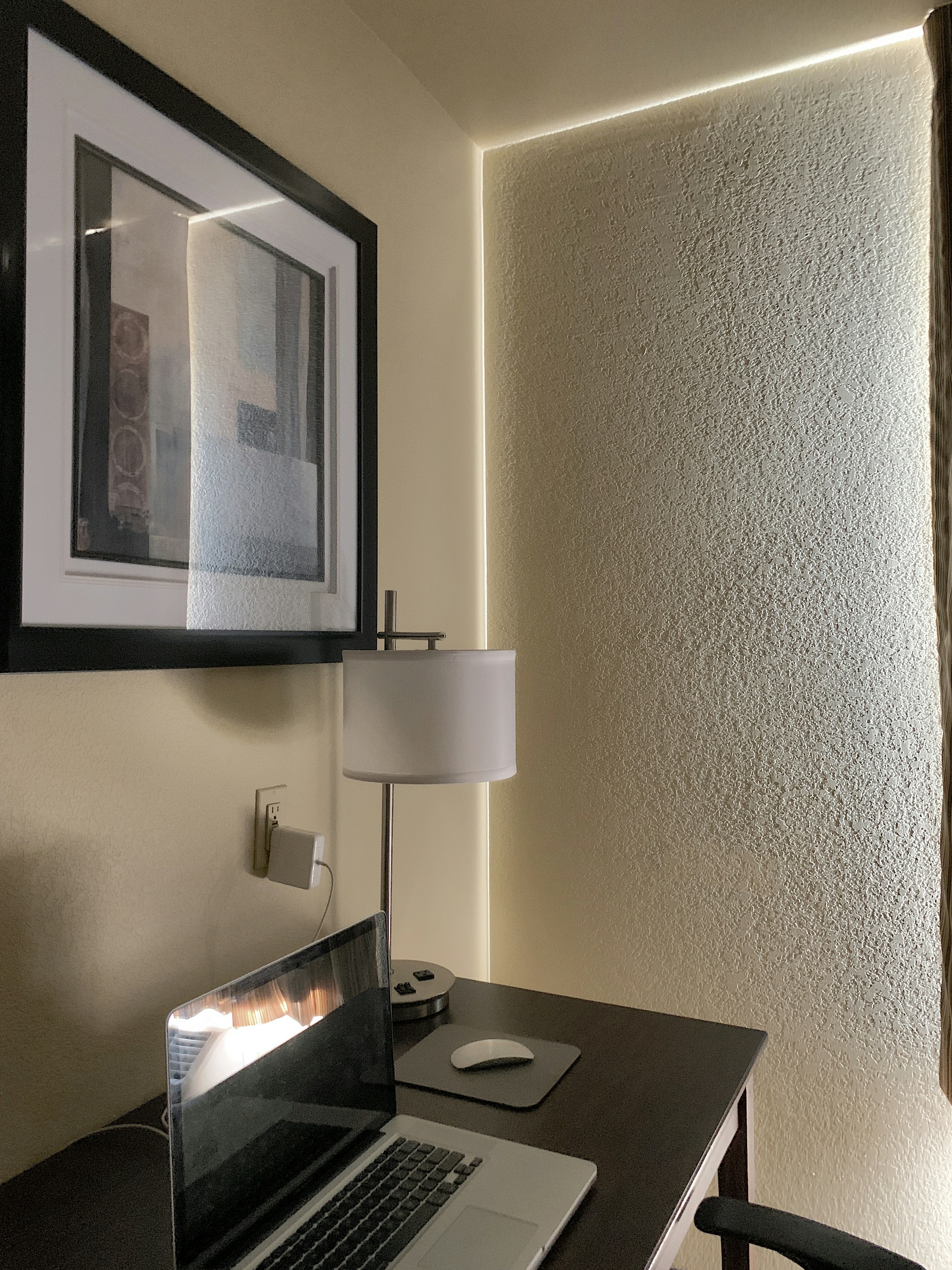 Laptop side profile on desk, bright ambient lighting