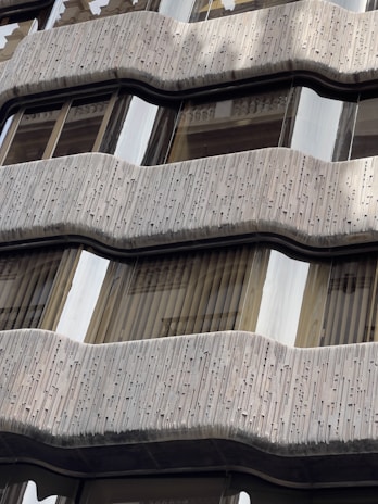 Close-up 3D rendering of architectural details such as balconies, windows, and textures on a building facade.
