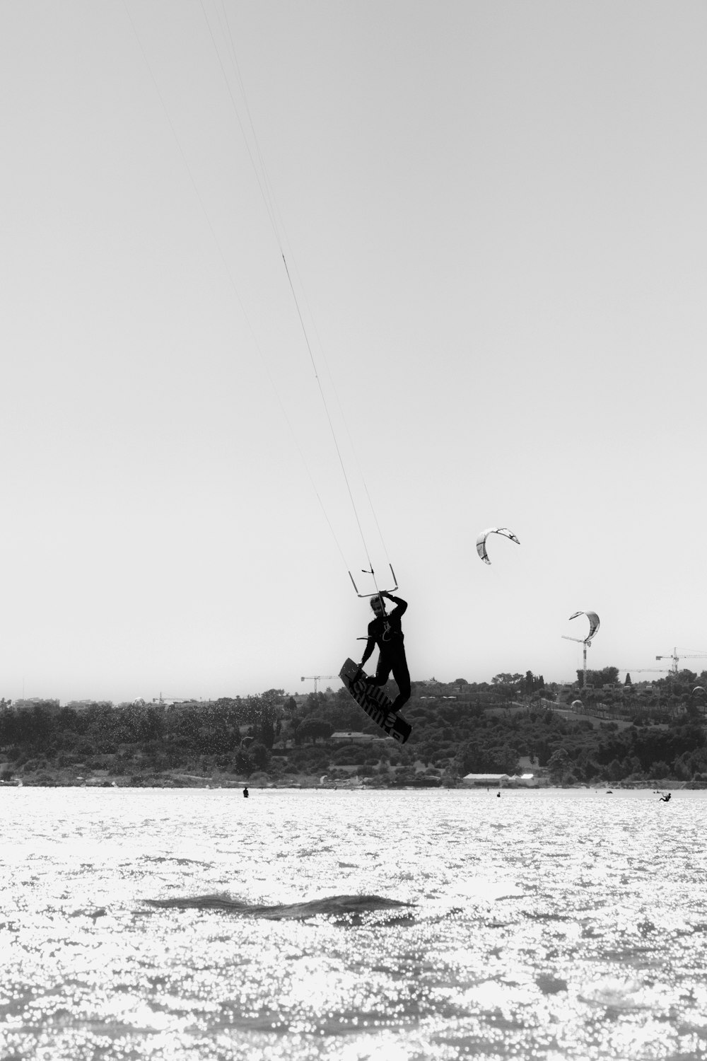 person in parachute in grayscale photography