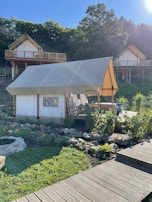 A group enjoying a glamping holiday surrounded by lush greenery and tents.