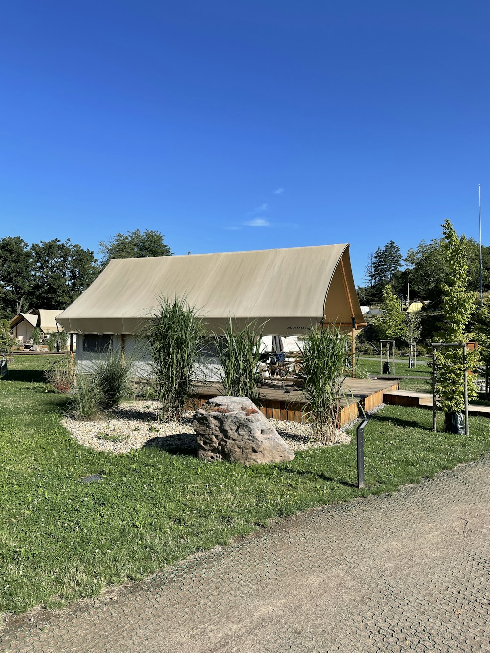 brown wooden house near green grass field during daytime