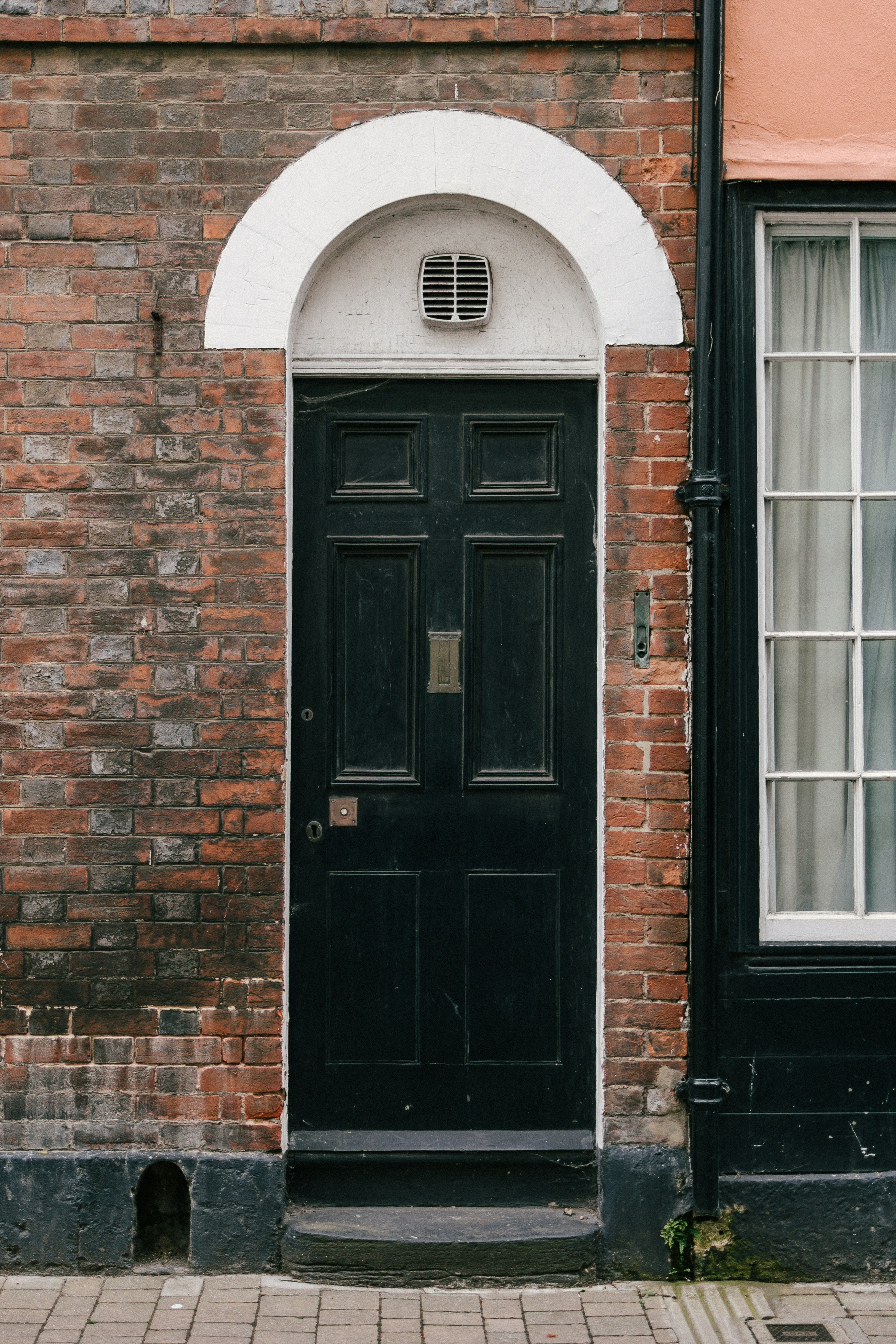 茶色のレンガの壁に黒い木製のドアの写真 Unsplashで見つけるオックスフォードの無料写真