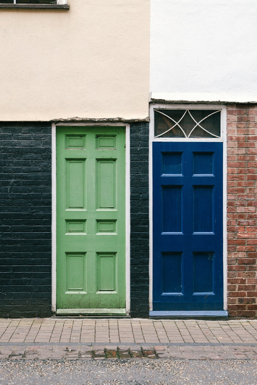 blue wooden window on brown brick wall