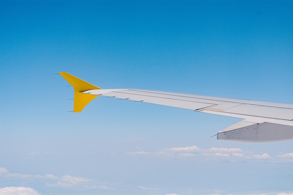 white and yellow airplane wing during daytime