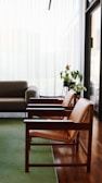 brown wooden framed gray padded armchairs