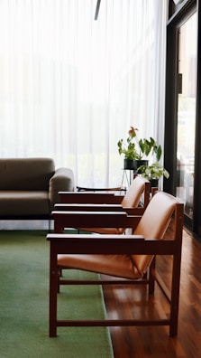 brown wooden framed gray padded armchairs