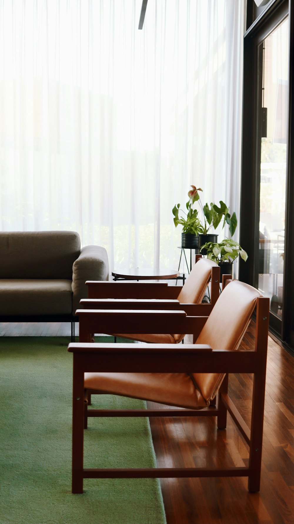 brown wooden framed gray padded armchairs