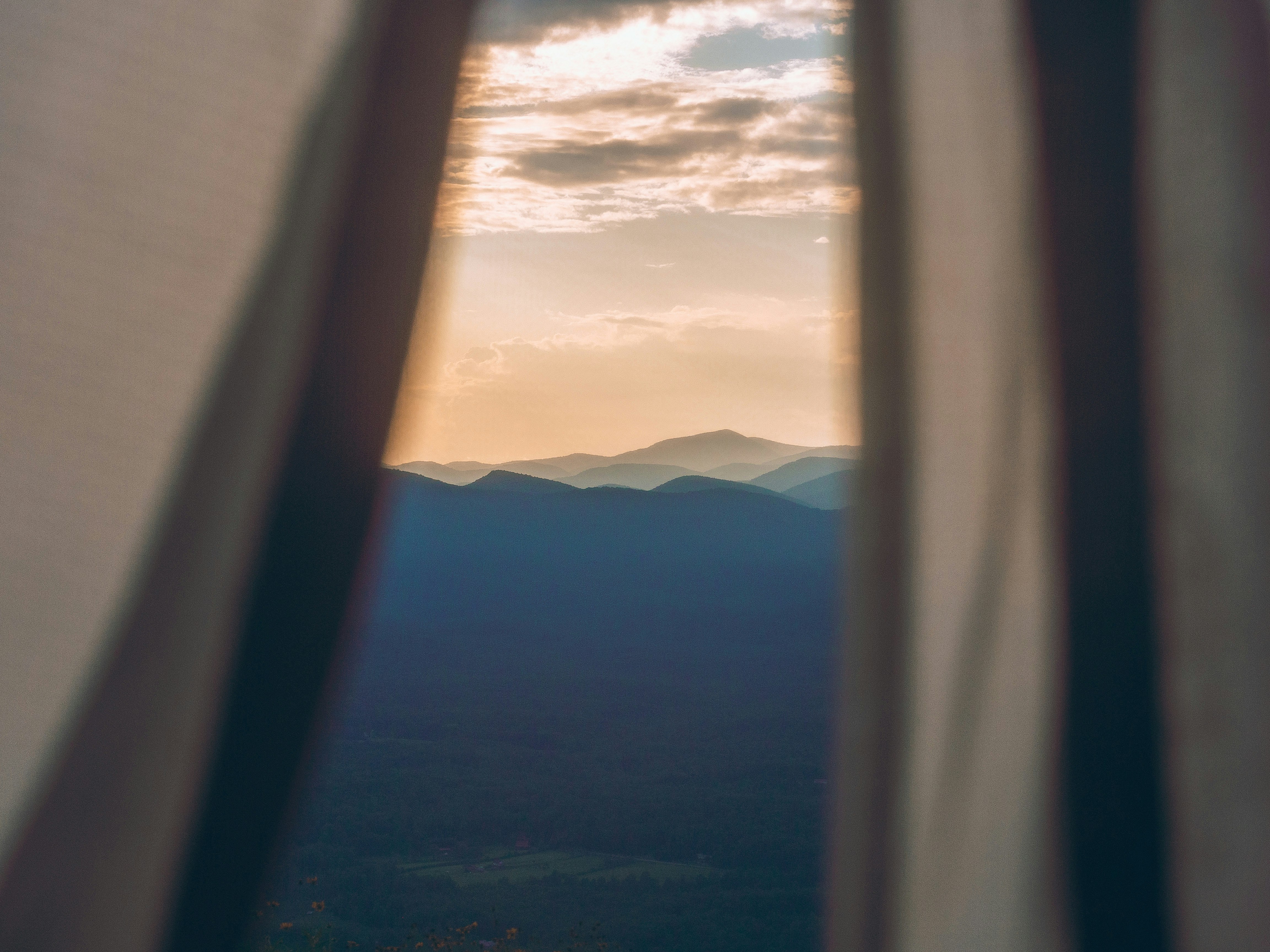 white clouds over mountains during daytime