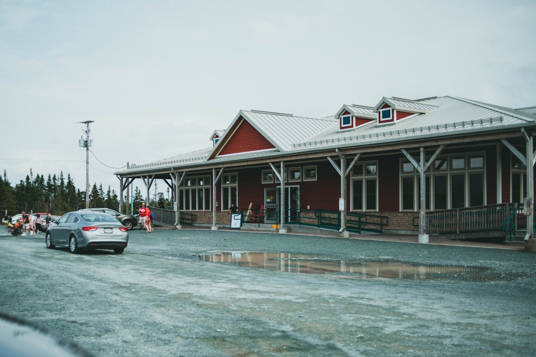 red and white wooden house near body of water during daytime