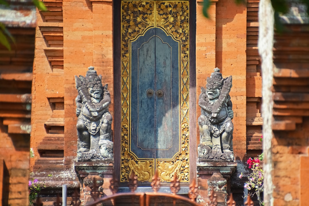 blue and gold door with statue