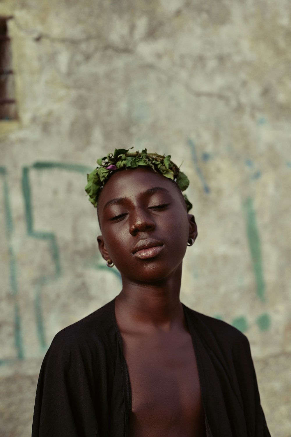 woman in black shirt wearing green floral head band