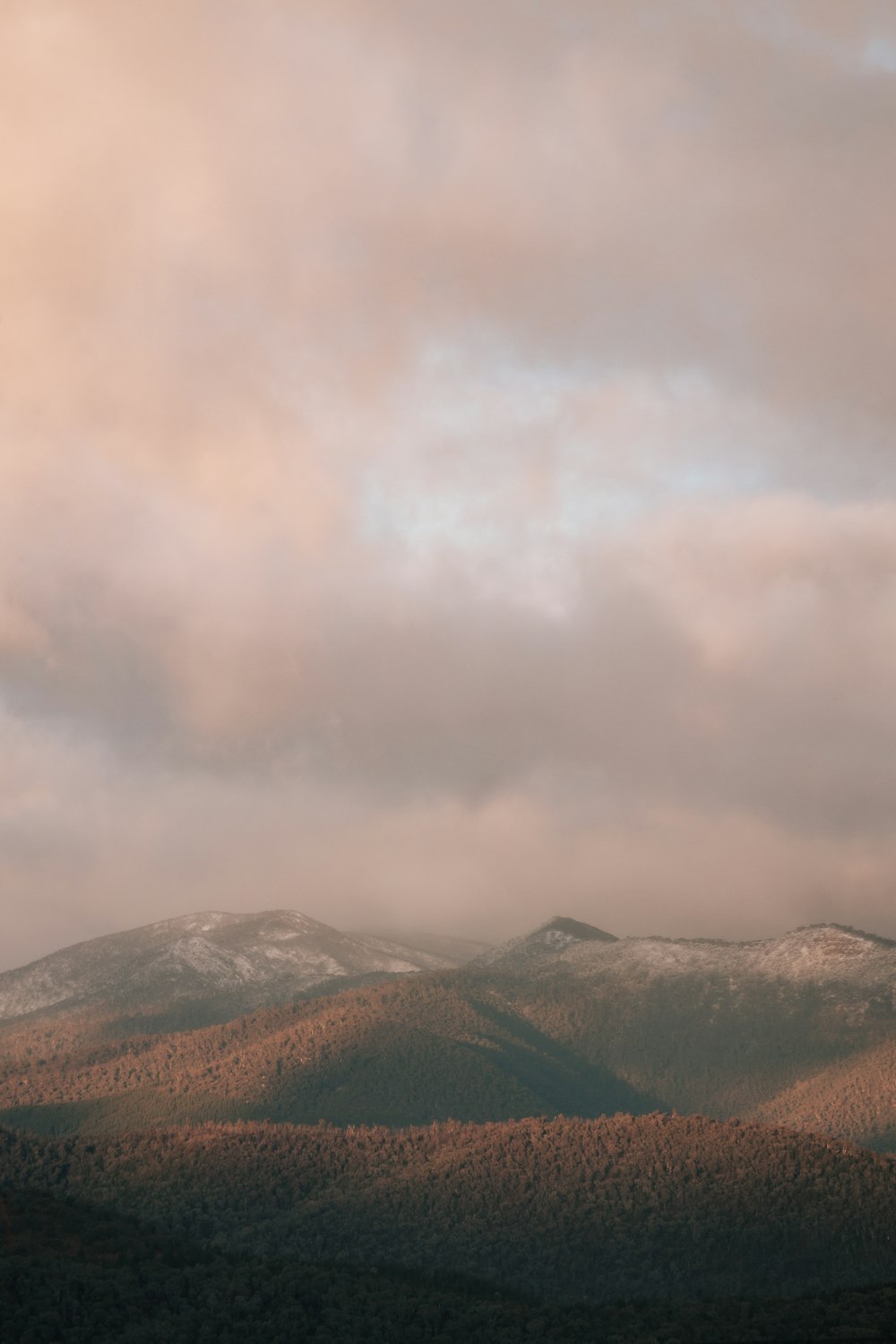 green and brown mountains under white clouds