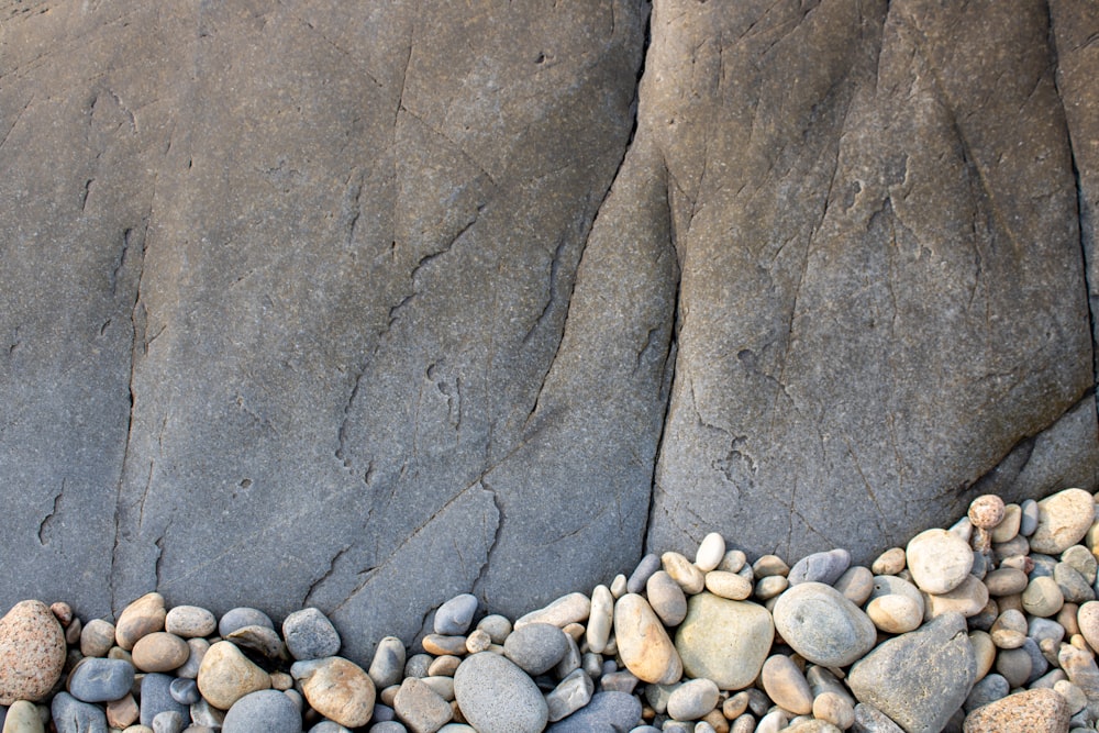 gray and black stones near brown concrete wall