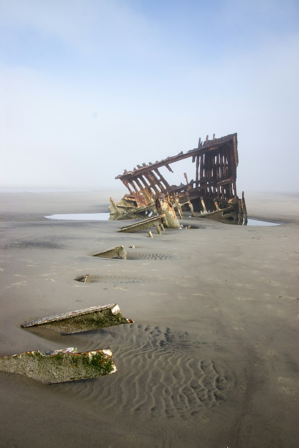 brown wooden ship on sea shore during daytime