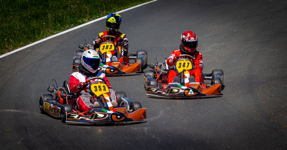 people riding on red and black go kart