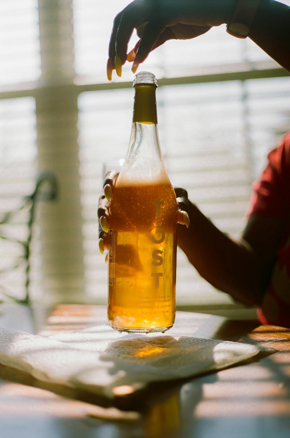 clear glass bottle with yellow liquid