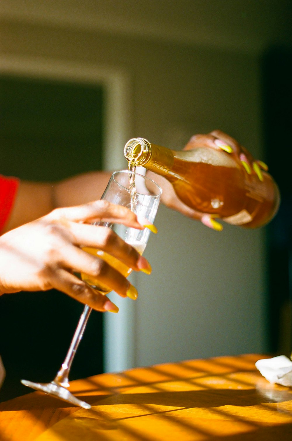 person holding clear glass bottle