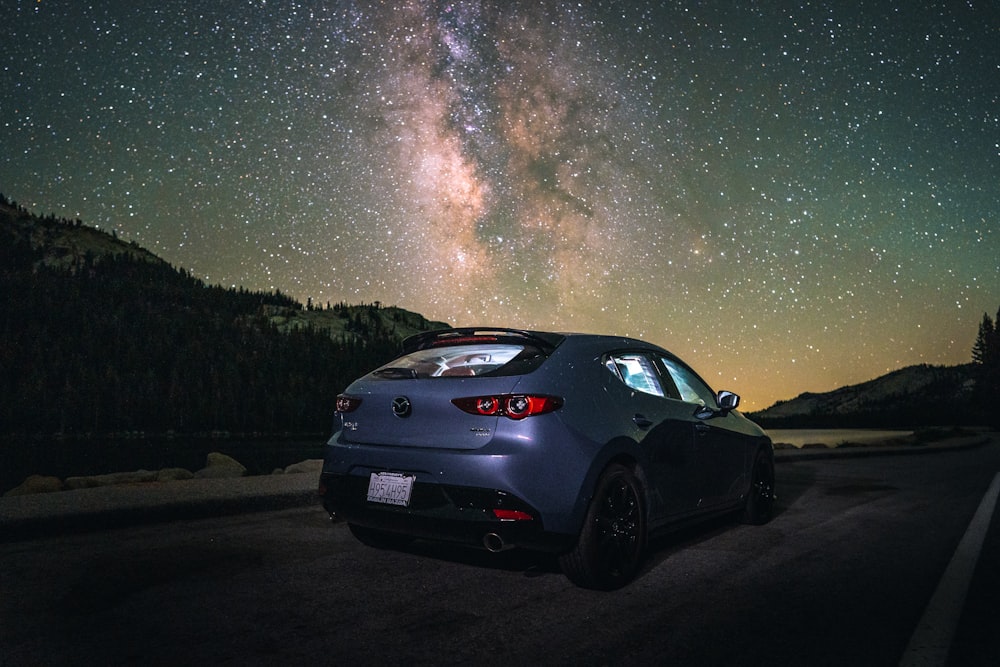 black car on road during night time