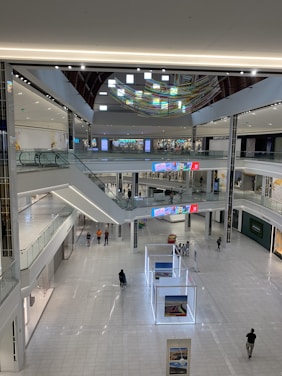 A clean, minimal digital interface showing a virtual mall map connecting to various real-world stores.