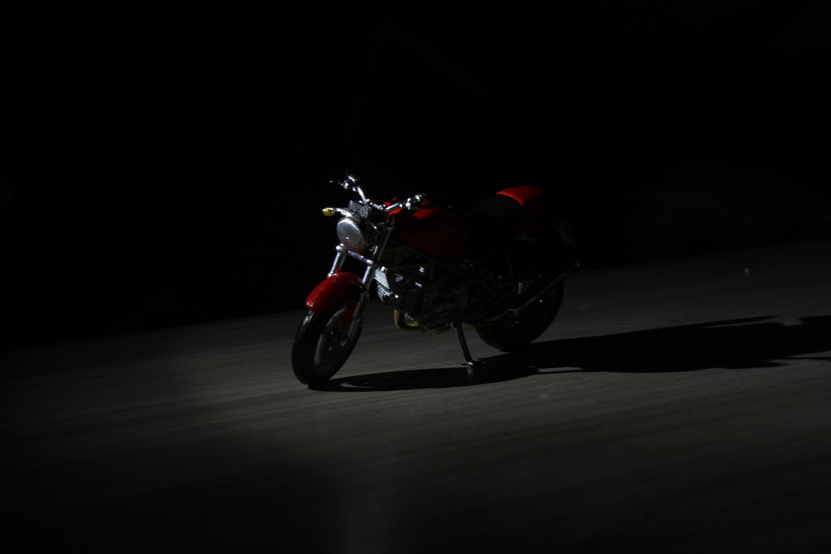 black and red motorcycle on gray road