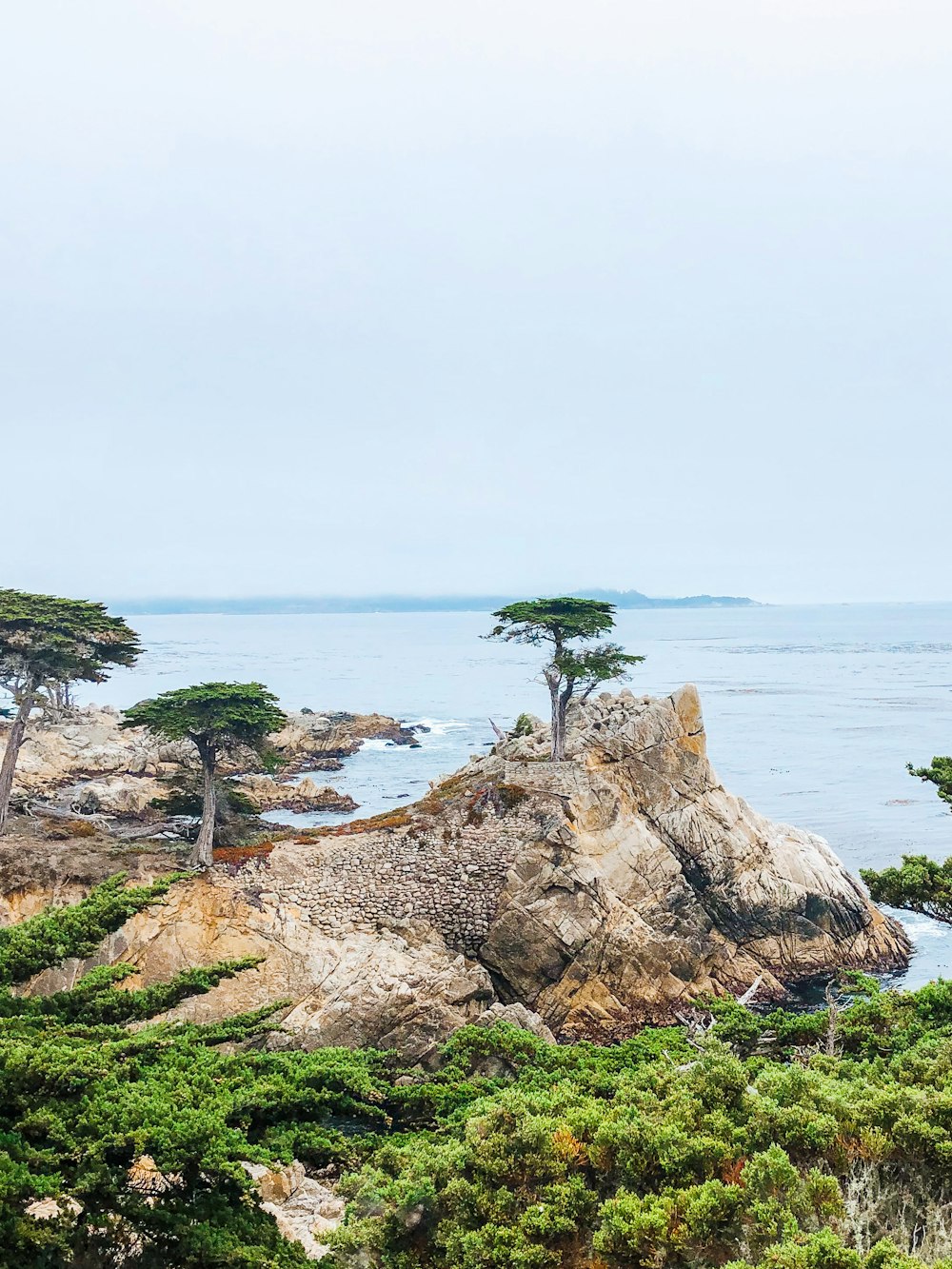 brown rock formation near body of water during daytime