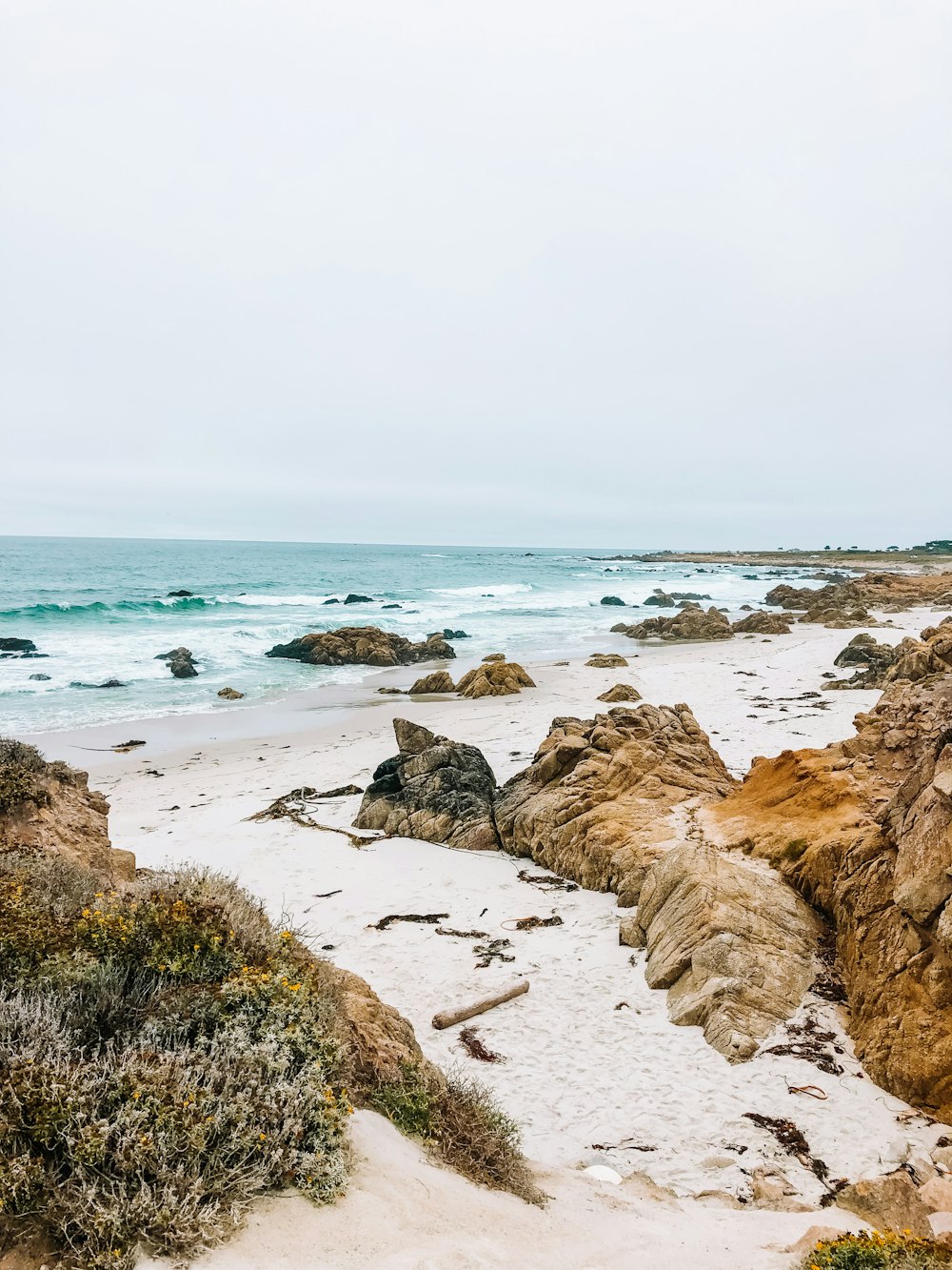 brown rock formation on seashore during daytime