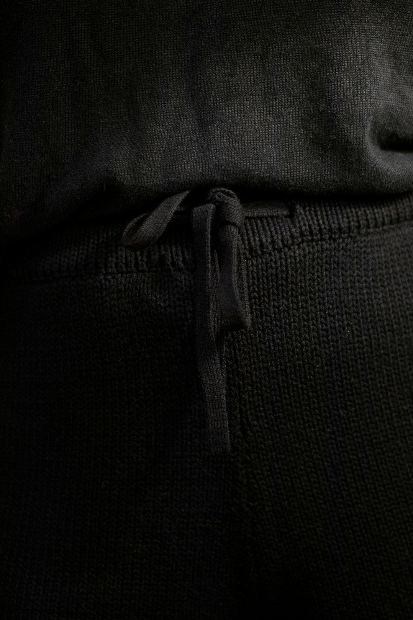 Black hoodie drawcord and ribbed hem detail