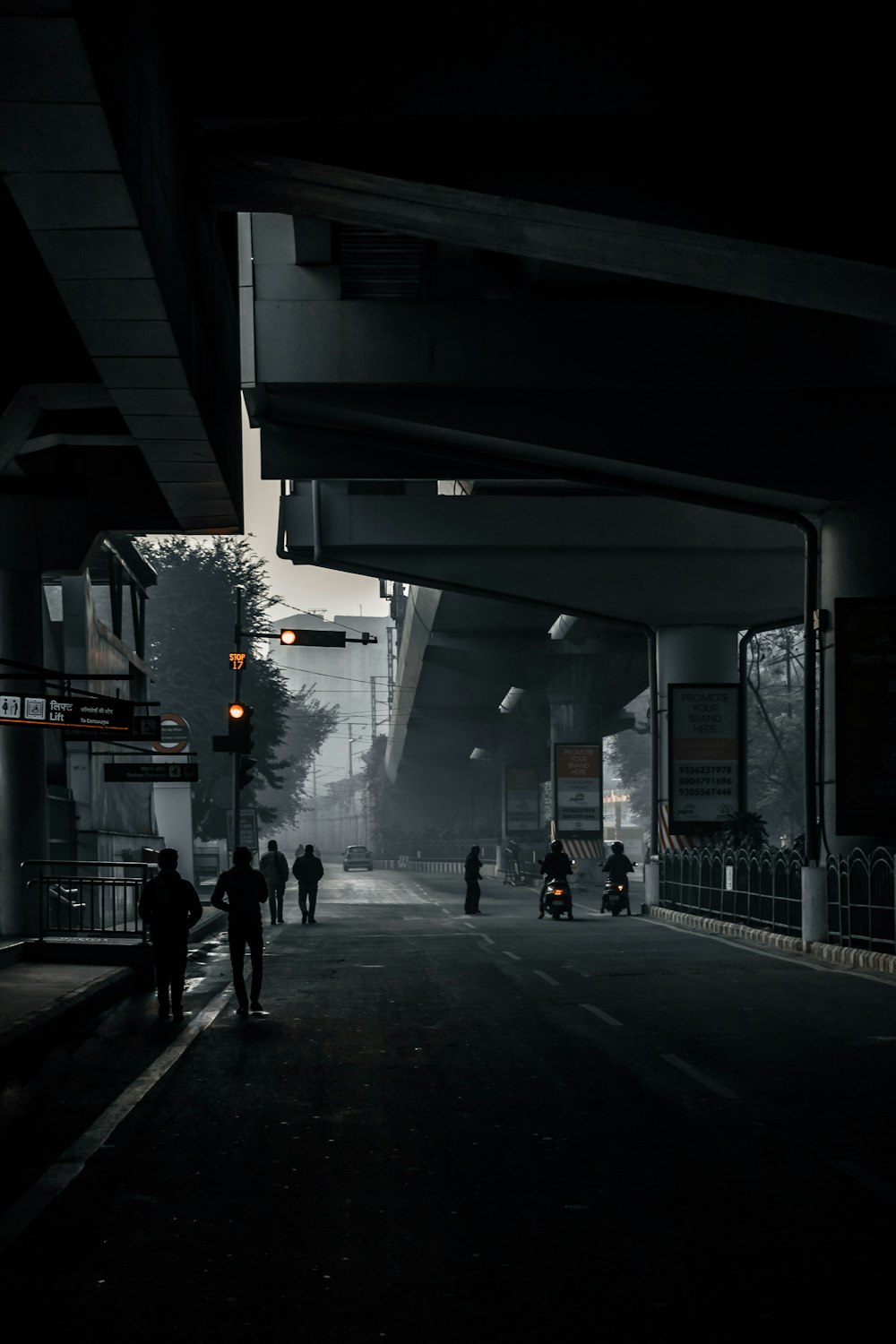 people walking on sidewalk during night time