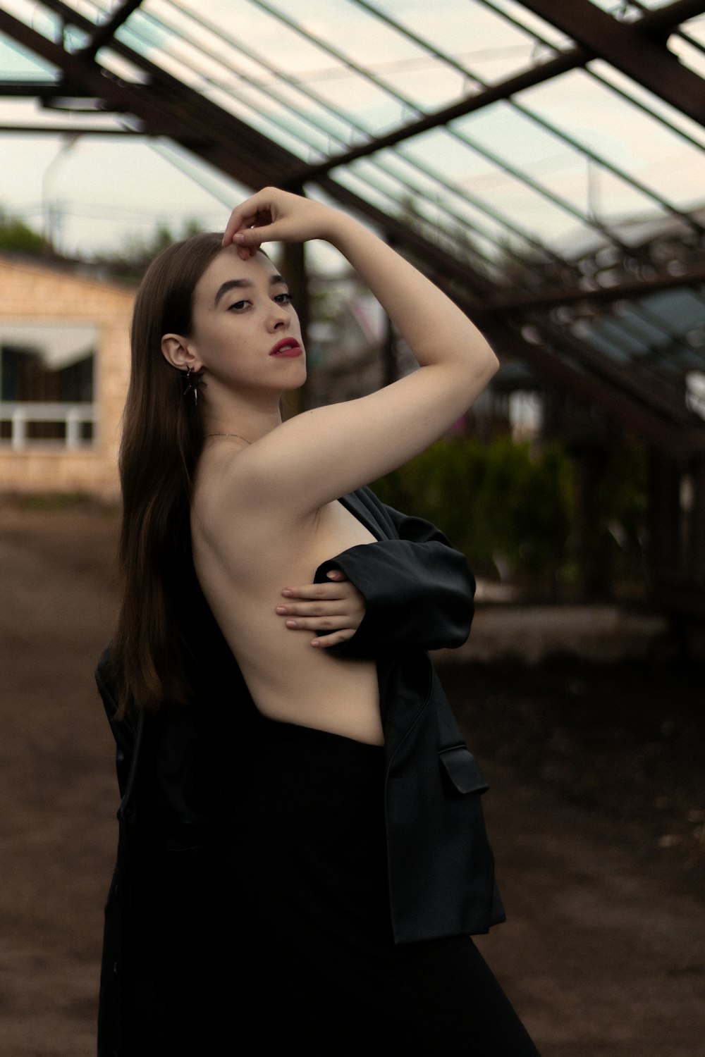 a woman in a black dress posing for a picture