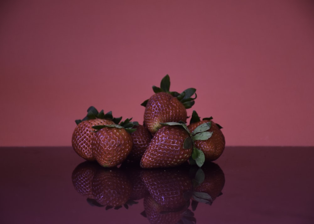 strawberries on pink plastic container