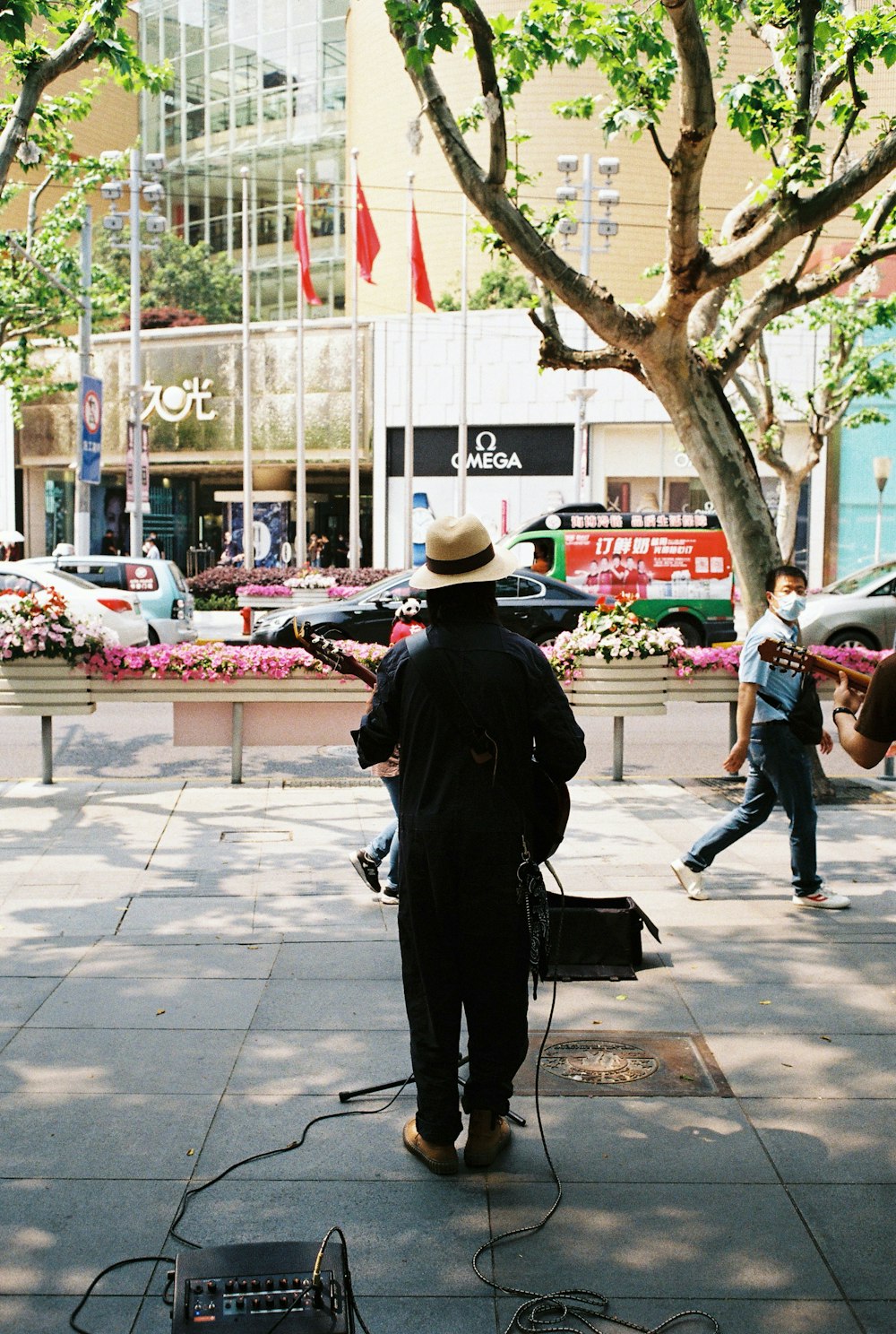 man in black coat standing near man in black jacket and blue denim jeans