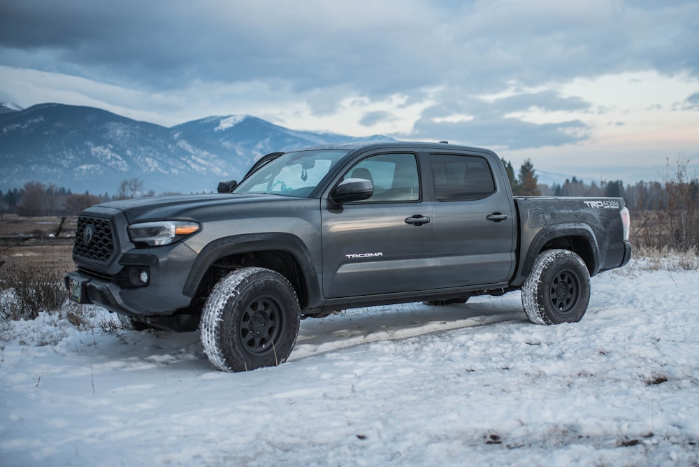 gray chevrolet crew cab pickup truck on snow covered ground during daytime