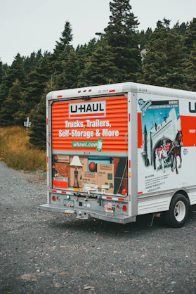 a moving truck parked on the side of a road