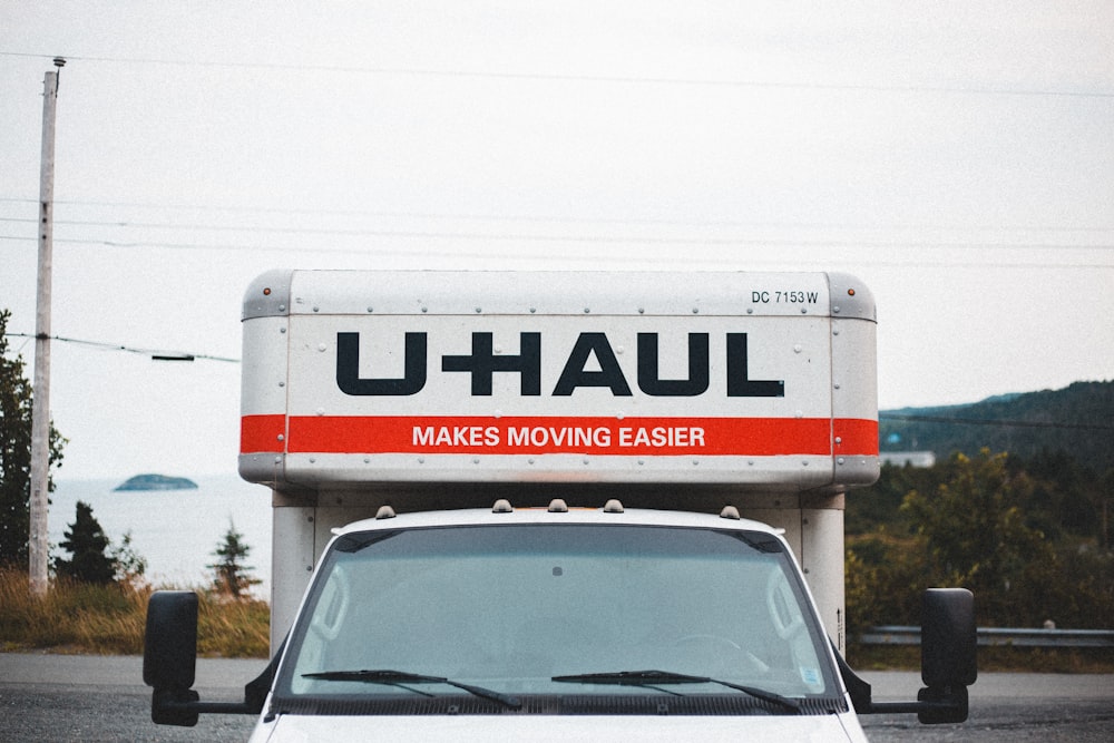 a white moving truck parked in a parking lot