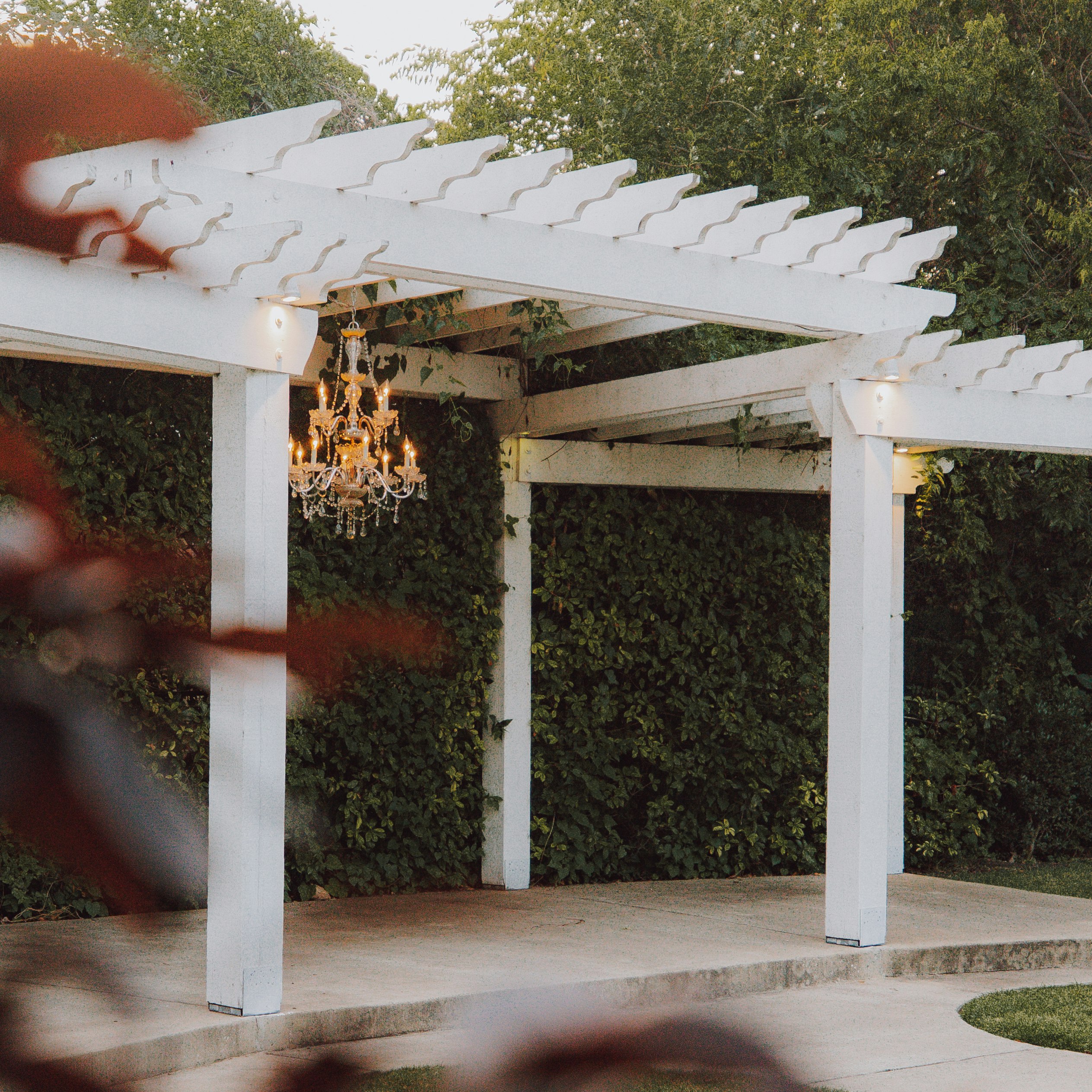 white wooden gazebo near green grass field during daytime