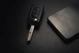 Set of traditional and modern car keys displayed neatly on a sleek black surface