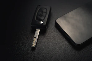 Set of traditional and modern car keys displayed neatly on a sleek black surface