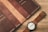 An elegant leather wallet displayed next to a stylish watch.