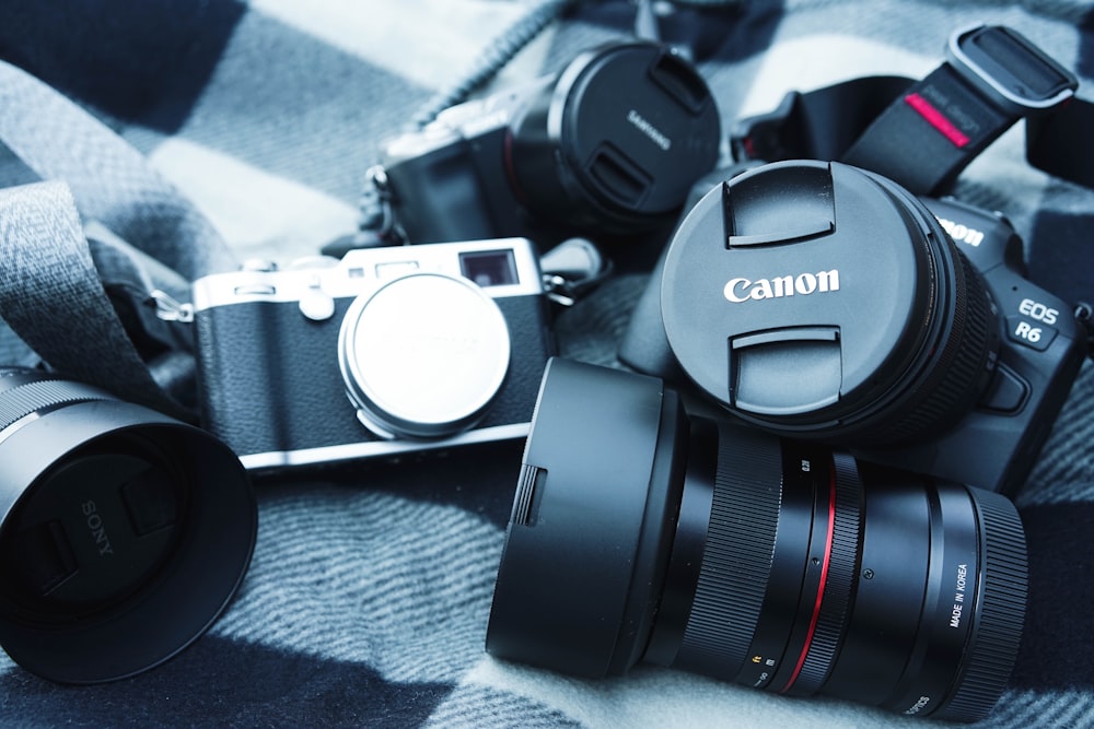 black and silver dslr camera on gray textile