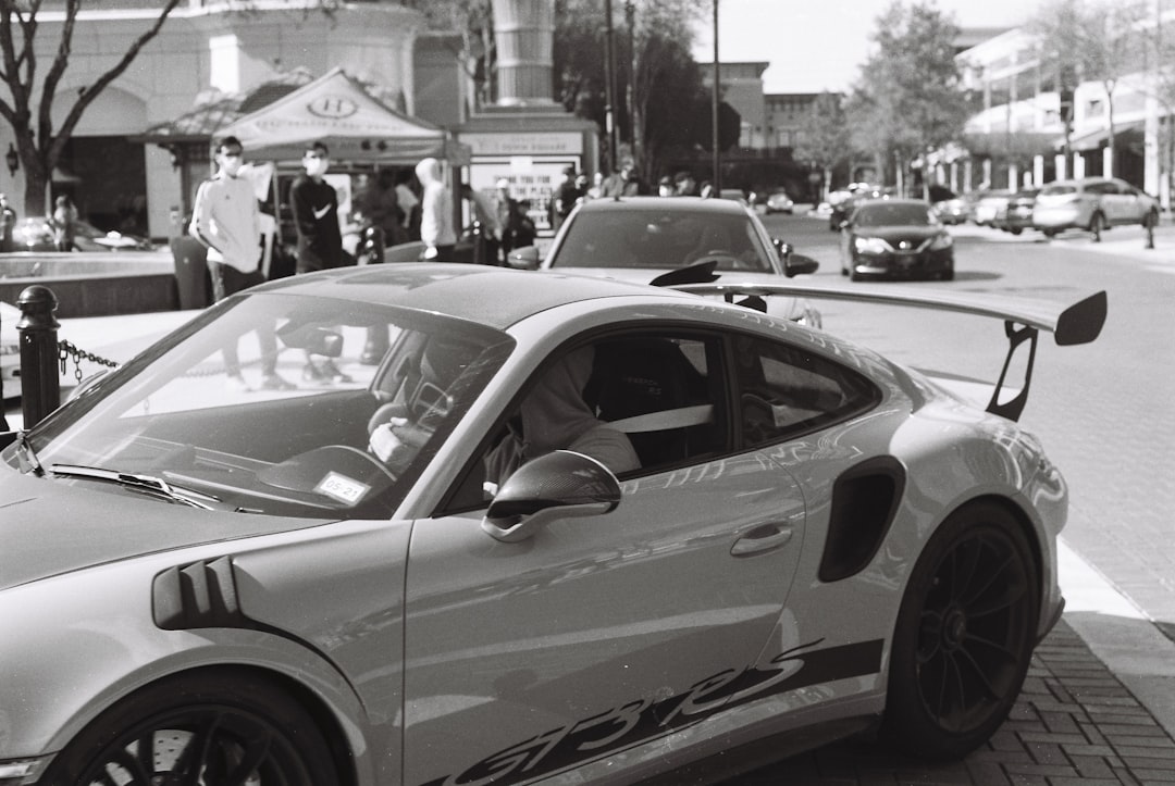 grayscale photo of white porsche 911