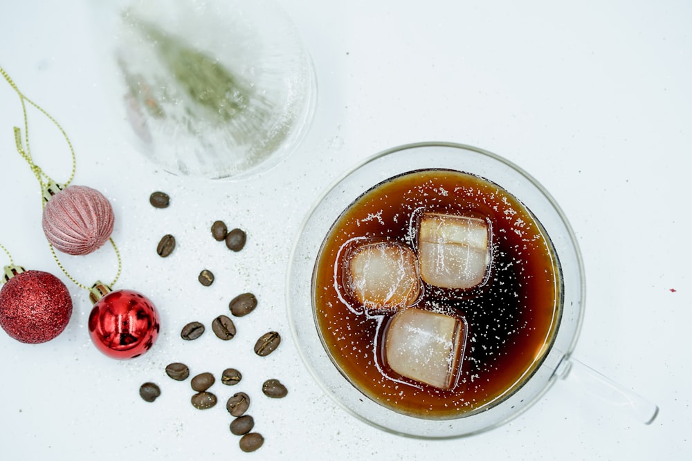 clear plastic cup with brown liquid