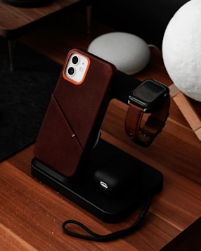 a cell phone sitting on top of a wooden table